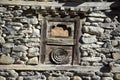 Weathered wooden window with flower motif in Nepal