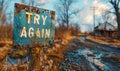 Weathered and worn TRY AGAIN sign stands by a country road, symbolizing persistence, second chances, motivation, and the