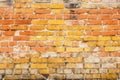 Weathered yellow and red brick wall, seamless pattern texture background. Royalty Free Stock Photo