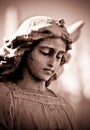Weathered young angel in sepia