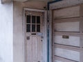 Weathers, dirty, unkempt front door and garage of residential home