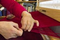 Weaver Adjusts Edge of Fabric She is Weaving