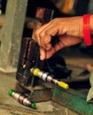 Working womans hand holding threads on a spool Royalty Free Stock Photo