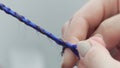 Weaving braids with blue artificial strands: a close-up