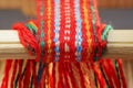 Weaving mini machine for making belts with patterns. Folk art, handmade. Detail.