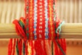 Weaving mini machine for making belts with patterns. Folk art, handmade. Detail.