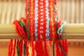 Weaving mini machine for making belts with patterns. Folk art, handmade. Detail. Royalty Free Stock Photo