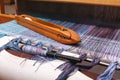 Weaving shuttle on the blue warp in weaving machine Royalty Free Stock Photo