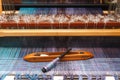 Weaving shuttle on the blue warp in weaving machine Royalty Free Stock Photo