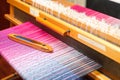 Weaving shuttle on the color warp in weaving machine Royalty Free Stock Photo