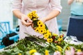 Weaving a wreath of wild flowers in a hand