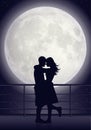 Couple kissing in moonlight