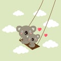 Happy koala bears riding on a swing.