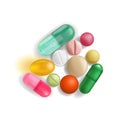 A handful of pills and vitamins of different colors and different sizes tightly lying next to each other, isolated on a white back