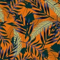 Summer bright original seamless pattern with tropical leaves and plants on an orange background. Vector design. Jung print. Floral Royalty Free Stock Photo