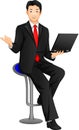 Businessman posing and holding laptop