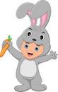 boy wearing rabbit costume holding a carrot