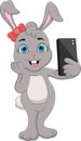 Cartoon happy rabbit taking a selfie