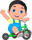 Little boy riding a tricycle and waving Royalty Free Stock Photo
