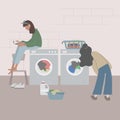 Young Women doing laundry. Teenage girls holding basket with clean clothes stand near washing machine Royalty Free Stock Photo