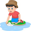 Boy playing with paper boat in a water Royalty Free Stock Photo