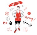 Muscular handsome strong guy stands in the gym surrounded by sports items.