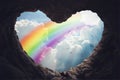 Heart shape cave with rainbow on sky over clouds close up, dreams, wishes, freedom Royalty Free Stock Photo