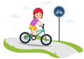 Traffic education. A cute little girl in a helmet rides a bike on a bike path.