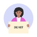Woman holding sign with gender pronoun She.