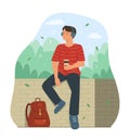 Traveler Man Sitting in Public Park and Listening Music from Headphones