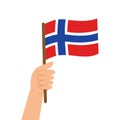 Hand holding a flag of Norway. Vector illustration of Norwegian flag in flat style.