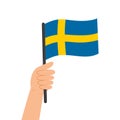 Hand holding a flag of Sweden. Vector illustration of Swedish flag in flat style.