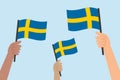 Diverse hands holding flags of Sweden. Vector illustration of Swedish flags.