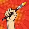 Hand with a painter brush. Drawing art illustration in pop art retro comic style