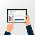 Web analytic information on Tablet screen held by hand. trend graphs report concept. statistic charts for planning and accounting