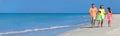 Web banner panoramic happy family of mother, father and two children, son and daughter, walking on a beach