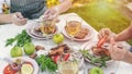 Web banner. People eat at the table with wine, grilled fish, fresh vegetables and herbs. Horizontal shot