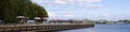 Web banner of a sailboat sailing with the pink beach umbrellas and Muskoka chairs in the foreground