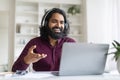 Web Conference. Smiling Indian Man In Headphones Making Video Call Via Laptop Royalty Free Stock Photo