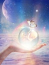 Cosmic womb, crystal ball with a baby inside, new born, star child, innocence, spiritual renewal, crystal children, indigo child Royalty Free Stock Photo