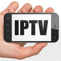 Web design concept: Hand Holding Smartphone with IPTV on display Royalty Free Stock Photo