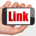 Web design concept: Hand Holding Smartphone with Link on display Royalty Free Stock Photo