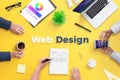 Web design team work on project concept. Yellow desk with web design text Royalty Free Stock Photo