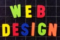 Web Design text with magnetic colorful letters on blackboard