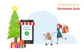 Happy woman with shopping cart enjoy online shopping and payment on smartphone during Christmas sale with Chrismas tree and gifts