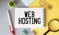 Web hosting business text concept. Text in notebook on table Royalty Free Stock Photo