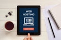 Web hosting concept on tablet screen with office objects