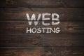 Web hosting handwritten on a wooden boards Royalty Free Stock Photo