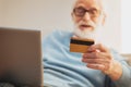 Modern pensioner paying for groceries online at the web-site