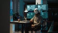 Web terrorist wearing mask hacking database servers Royalty Free Stock Photo